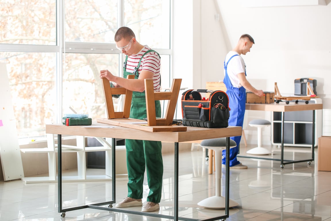 Handymen Assembling Furniture in Workshop