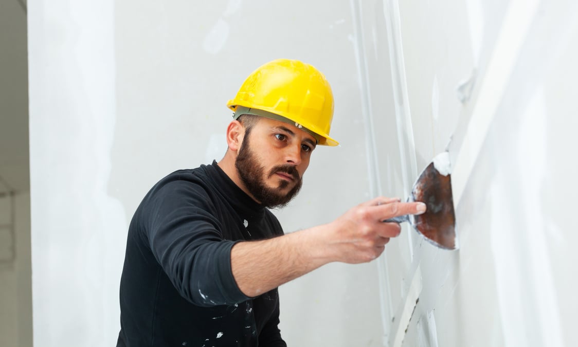 Worker Plastering Gypsum Board Wall.